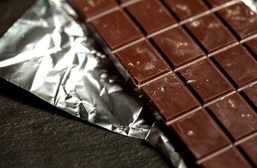 Handmade raw vegan chocolate on black background