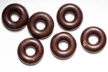 Raw vegan homemade chocolate candy balls on a white background. Top view in the form of donuts