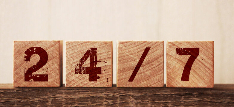 24 slach 7 text on cubes on wooden background. Support clients concept