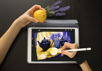 A girl in a special glove draws a still life picture with a pencil on an electronic tablet. The concept of inspiration, creativity, self-development, hobby, art
