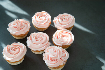 Cupcakes with butter cream on dark background