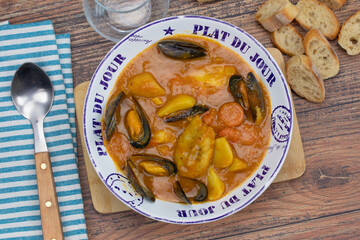 assiette de bouillabaisse sur une table en bois