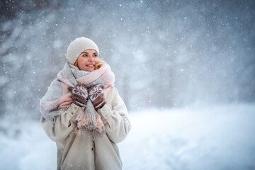 Smiling woman enjoying winter among snow outdoor