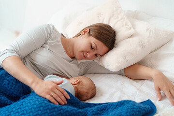 happy young woman feeds breast milk and hugs baby. a mother is breastfeeding