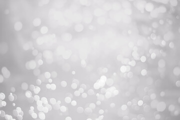 White glitter vintage lights background. White bokeh background.