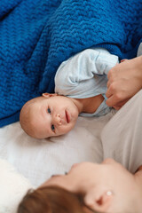 happy young woman feeds breast milk and hugs baby. a mother is breastfeeding