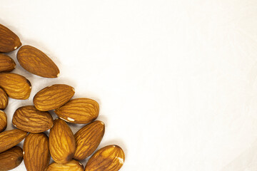 small almond frame on crumpled paper background