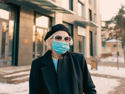 Senior Stylish Woman In Beret And Elegant Black Coat And In Medical Mask Walking Outdoor. Lockdown, Pandemic, Protection Concept 