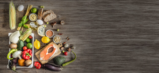 Plenty of foods on the wooden table.