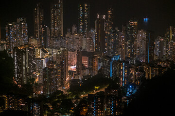 A couple of trekkers hike in the night above Pok Fu Lam reservoir in Hong Kong. 