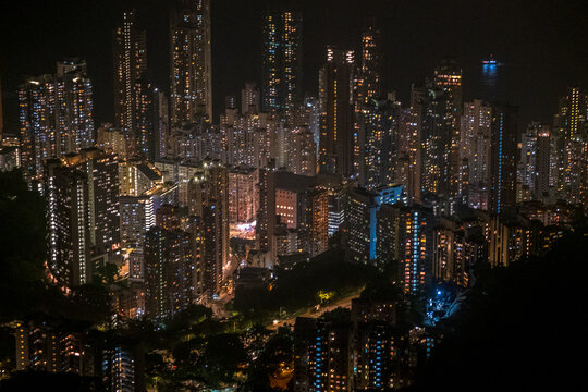 A Couple Of Trekkers Hike In The Night Above Pok Fu Lam Reservoir In Hong Kong. 