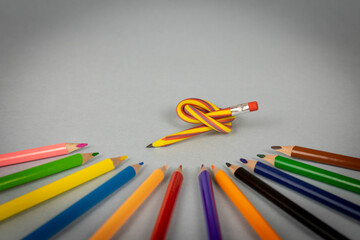 Multicolor pencils and flexible pencil on a light background. Close up. Selective focus.