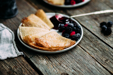 Thin Pancakes with jam and berries. Breakfast. Maslenitsa holiday