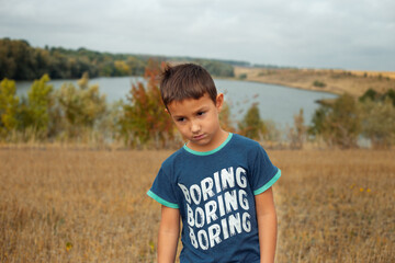 Borring boy with borring sign on the t-shirt

