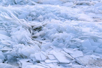 Cracked blue ice on a winter lake. Eastern Europe. Landscape. Background texture. Horizontal orientation.