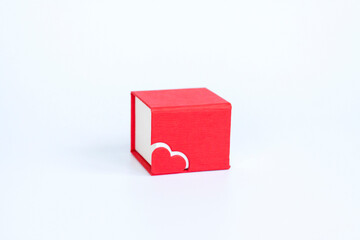 Red box for decoration with a heart on a white background. Make a Declaration of love. The concept of the Valentine's Day theme.