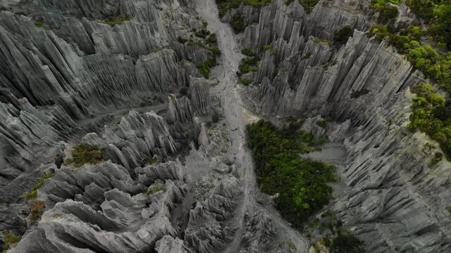 Stunning birds eye view of sharp rock formations and river valley. Geological wonder made by erosion, New Zealand