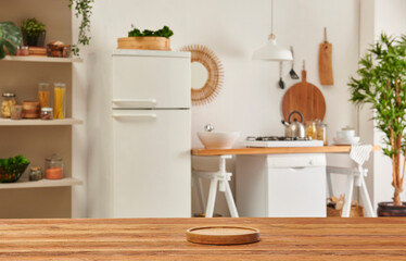 Close up wooden table and decorative kitchen background style. Refrigerator, dishwasher and stove style with lamp concept.