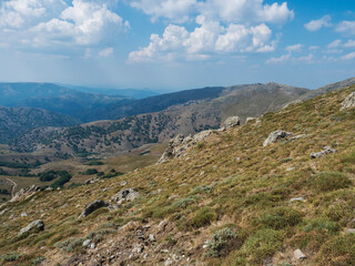 Mountain landscape in Gennargentu, highest mountain in Sardinia, Nuoro, Italy. Vaste peaks, dry plains and valleys with mediterranean vegetation. Late summer, blue sky