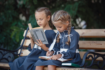 Fototapeta premium Charming little girls in retro dress walking in town on a sunny summer day