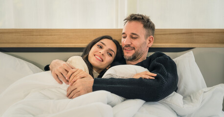 couple having romantic moment together on bed at home in winter
