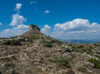 View of limestone tower Perda Liana, impressive rock formation on green forest hill, sardinian...
