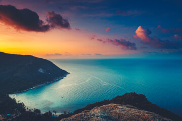 Silhouette Thailand aerial: sunset island sea bay at highland rainforest, sand beach coastline of...