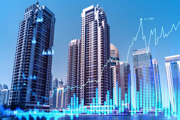 Skyscrapers of Dubai business downtown. International hub of trading and financial services of Western Asia. FOREX graph and chart concept. Double exposure. Dubai Canal waterfront.