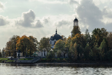 View from the water to the Church of the Holy Blessed Grand Duke Alexander Nevsky in Ust-Izhora in autumn. Boat trip. Russia, St. Petersburg, September 30, 2020.