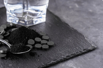 activated carbon on a dark stone background