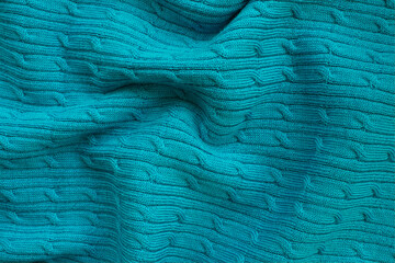 Seamless knitted fabric with pigtails. Knitted sweater, plaid, scarf. Knitted background