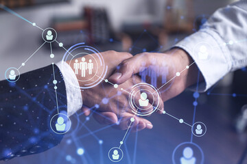 Recruitment concept of hiring of a new talented specialists for international company. Handshake as a concept of agreement to sign an employment contract. Social media hologram icons.