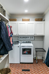 Laundry room with washer and dryer inside a master bedroom walk in closet