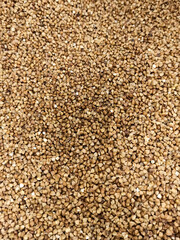 Close up background buckwheat, food topic, black and gold colour, volume texture