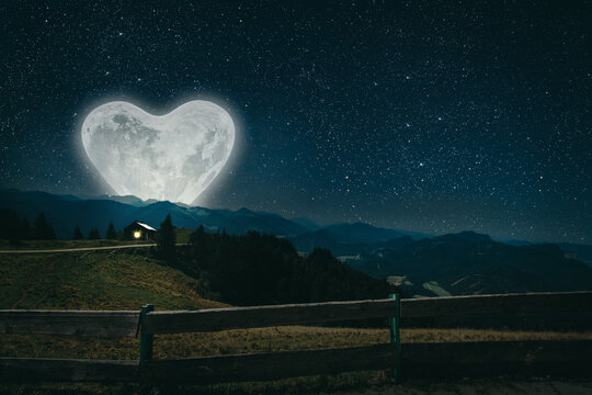The moon heart-shaped shines over the lovers' house on valentine's day