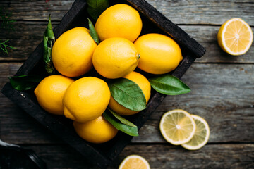 Lemons in a wooden box on a table Rustic style