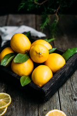 Lemons in a wooden box on a table Rustic style