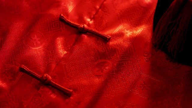 mandarin oranges and chinese red envelope with males cheongsam on wood background