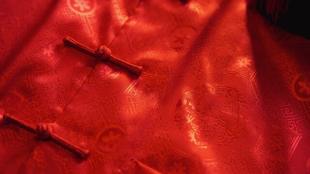 mandarin oranges and chinese red envelope with males cheongsam on wood background