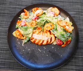 food on a plate caesar salad pasta with shrimp