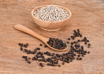 White pepper and   black pepper on old wooden