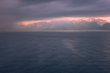 Fototapeta premium Beautiful pinky sunrise over the sea and mountains in Antalya, Turkey