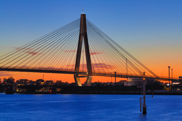 Fototapeta na wymiar Anzac Bridge at Sunset orange and blue skies Sydney NSW Australia