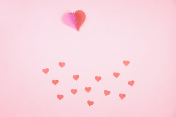 Heart shaped paper sticked on pink background. Emblem of love for happy women, beloved mother,...
