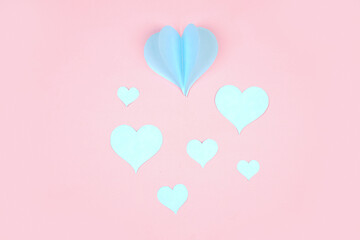 Heart shaped paper sticked on pink background. Emblem of love for happy women, beloved mother, birthday cards and valentine greeting designs. Valentine's day backgrounds. Templates to convey our love.
