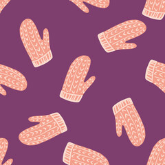 Random pink doodle mittens seamless pattern in cozy style. Purple background. Clothes winter print.