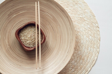 Fototapeta na wymiar parboiled rice in wooden bowl with wooden chopsticks