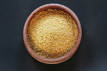 A cereals millet in wooden bowls  top view