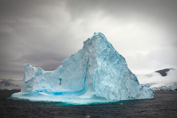 Impressive iceberg with a special sky in the Gerlache Strait in Antarctica.