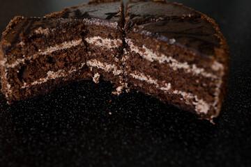 Chopped up chocolate cake with filling visible Close-up. Cake filling